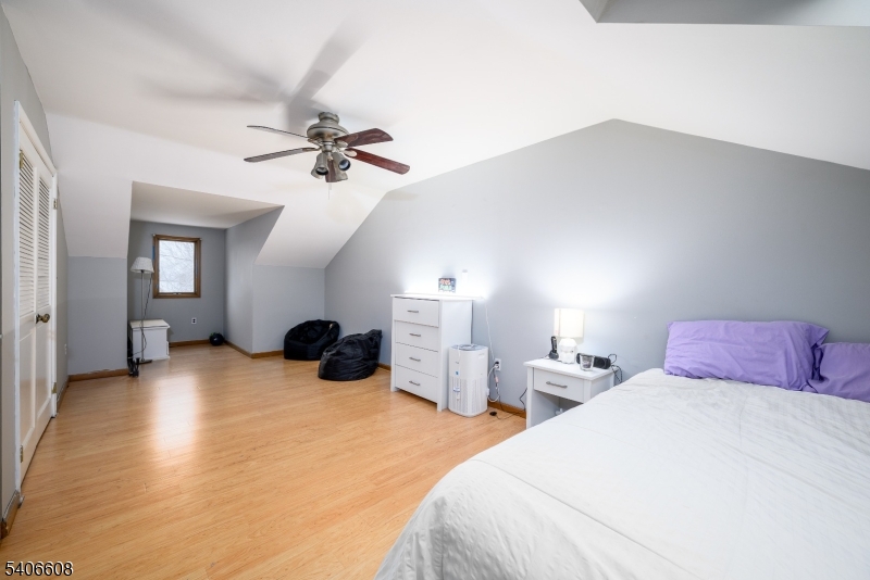 900 Valley Road, Unit D1O Clifton, NJ 07013 - Photo 12 of 16 a bedroom with two bed and a chandelier