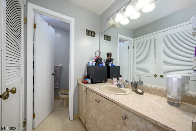 900 Valley Road, Unit D1O Clifton, NJ 07013 - Photo 15 of 16 a bathroom with a sink vanity and a mirror
