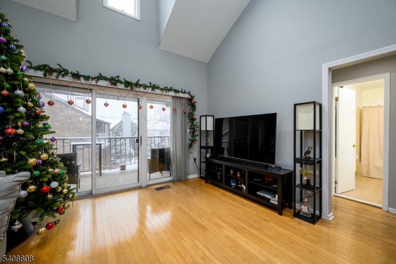 900 Valley Road, Unit D1O Clifton, NJ 07013 - Photo 2 of 16 a living room with furniture and a flat screen tv