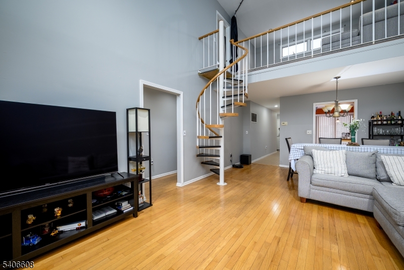 900 Valley Road, Unit D1O Clifton, NJ 07013 - Photo 3 of 16 a living room with furniture and a flat screen tv