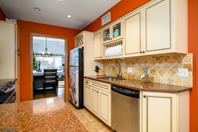 900 Valley Road, Unit D1O Clifton, NJ 07013 - Photo 5 of 16 a kitchen with stainless steel appliances granite countertop a refrigerator and a stove