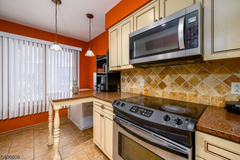 900 Valley Road, Unit D1O Clifton, NJ 07013 - Photo 6 of 16 a stove top oven sitting inside of a kitchen