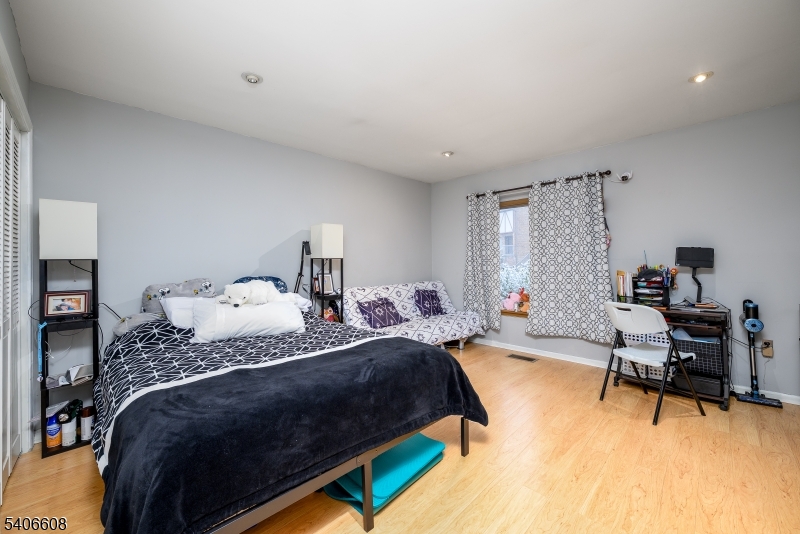 900 Valley Road, Unit D1O Clifton, NJ 07013 - Photo 8 of 16 a bedroom with a bed a desk and chair