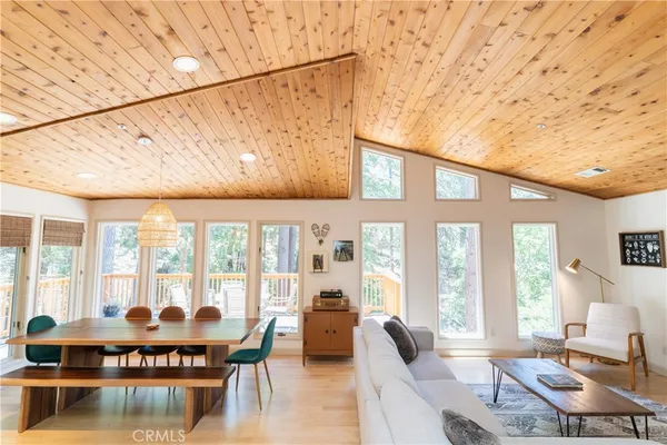 a living room with furniture and large windows