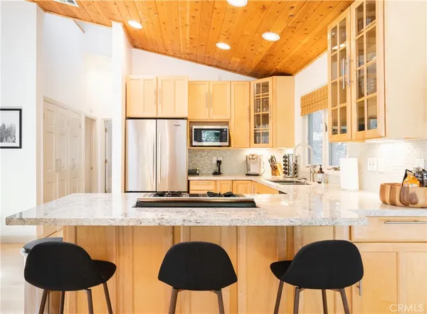 a kitchen with stainless steel appliances granite countertop a sink and a white cabinets