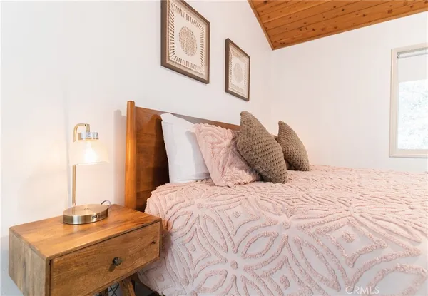 a bedroom with a bed and a table