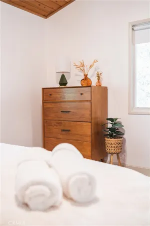 a bedroom with a bed and dresser