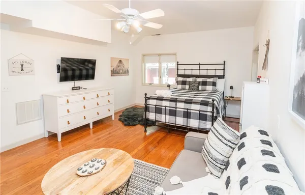 a bedroom with furniture and a flat screen tv