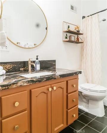 a bathroom with a toilet a sink and a shower