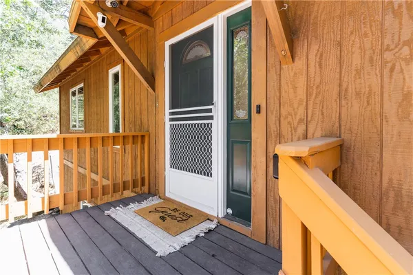 a view of backyard with wooden floor and fence