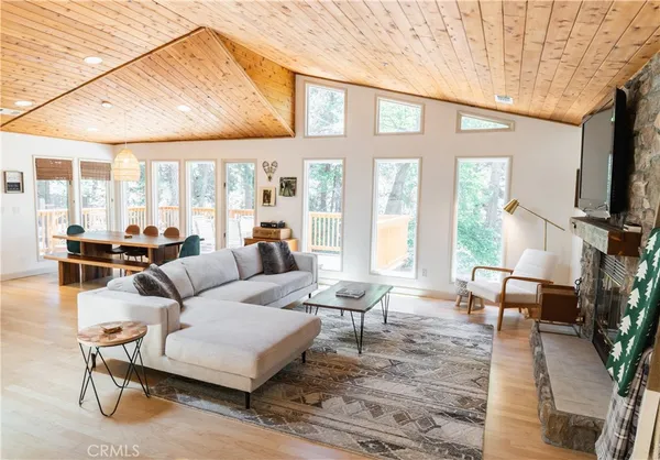 a living room with furniture fireplace and a large window