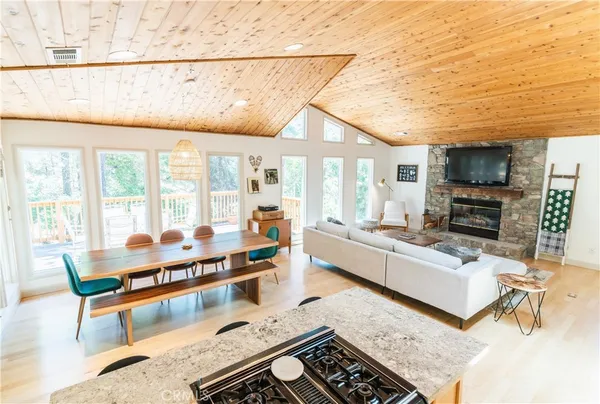 a living room with furniture a flat screen tv and a table