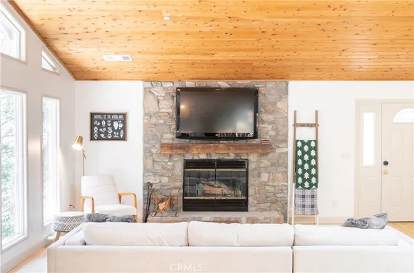 a living room with a fireplace and a flat screen tv