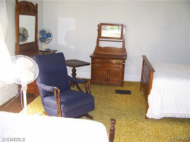 2329 Jonesboro Road Kenbridge, VA 23944 - Photo 5 of 12 a living room with couches chairs and dresser with wooden floor