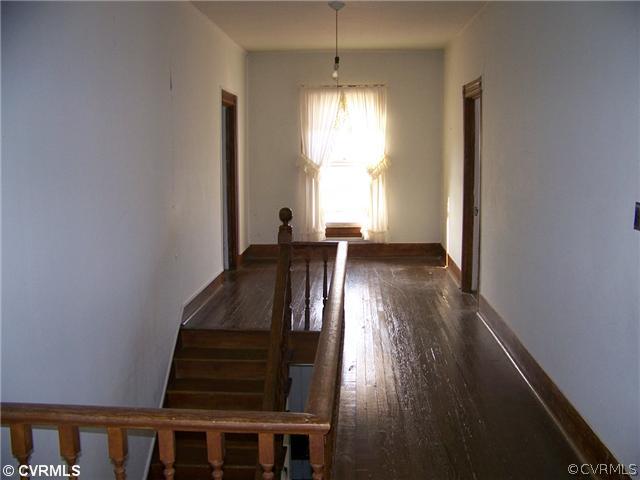 2329 Jonesboro Road Kenbridge, VA 23944 - Photo 6 of 12 a view of a hallway with wooden floor and staircase