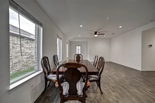 a view of a dining room with furniture and window