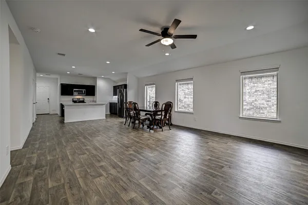 a view of a livingroom with furniture and a ceiling fan