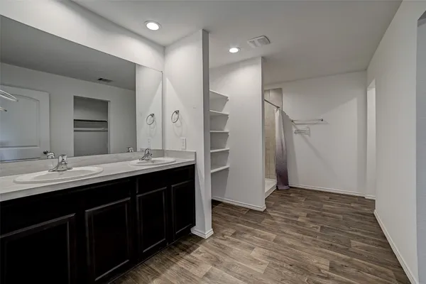 a bathroom with a double vanity sink and mirror