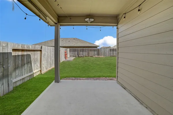 a view of a house with backyard and porch