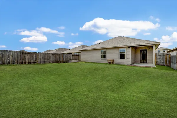 a front view of house with a garden