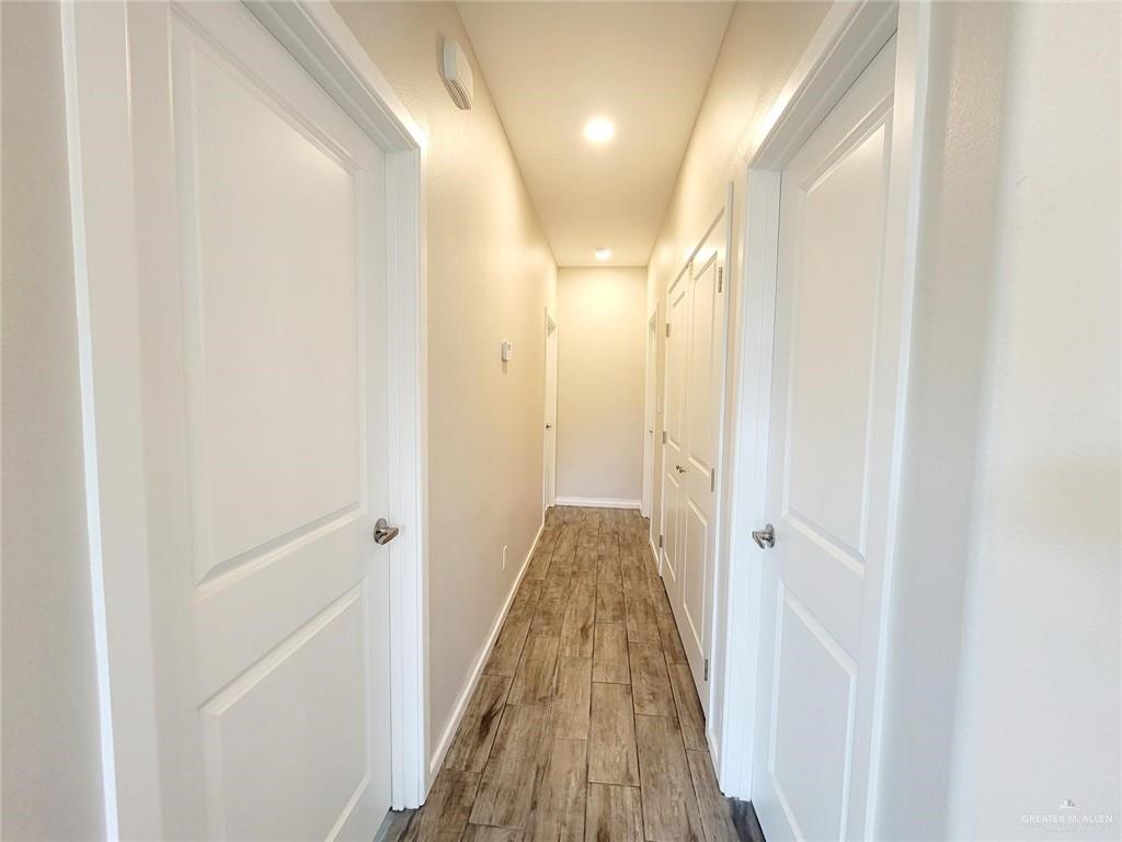 5801 Swallow Avenue, Unit 1 Mission, TX 78573 - Photo 10 of 11 a view of a hallway with wooden floor and a glass door