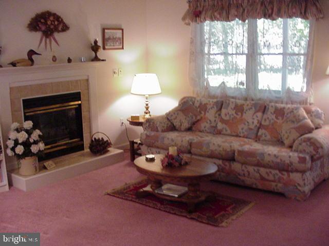 108 Sandyhook Road Ocean Pines, MD 21811 - Photo 5 of 19 a living room with furniture a window and a fireplace
