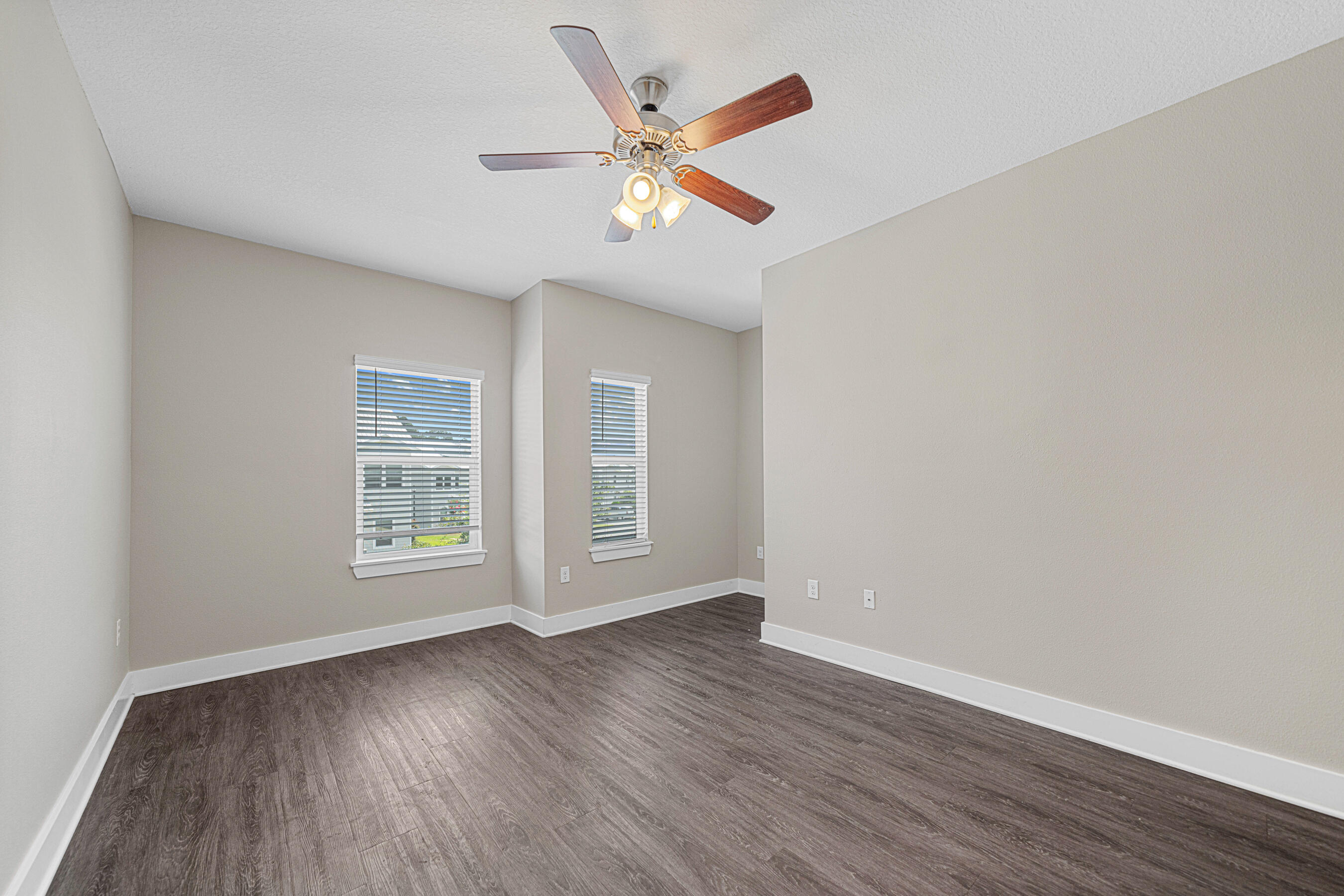 182 North Sand Palm Road Freeport, FL 32439 - Photo 15 of 38 an empty room with wooden floor fan and windows