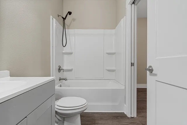 a bathroom with a sink a toilet and a bathtub