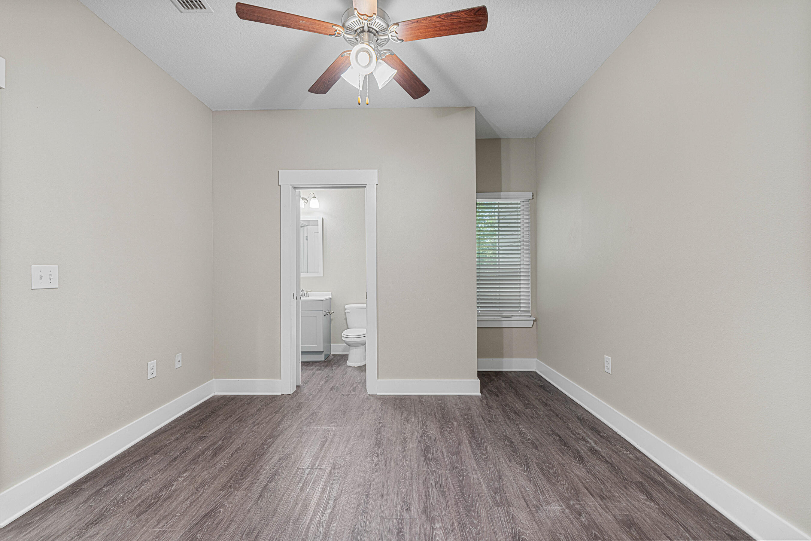 182 North Sand Palm Road Freeport, FL 32439 - Photo 19 of 38 wooden floor in an empty room with a window