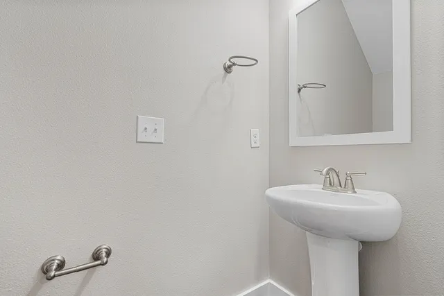a bathroom with a sink and mirror
