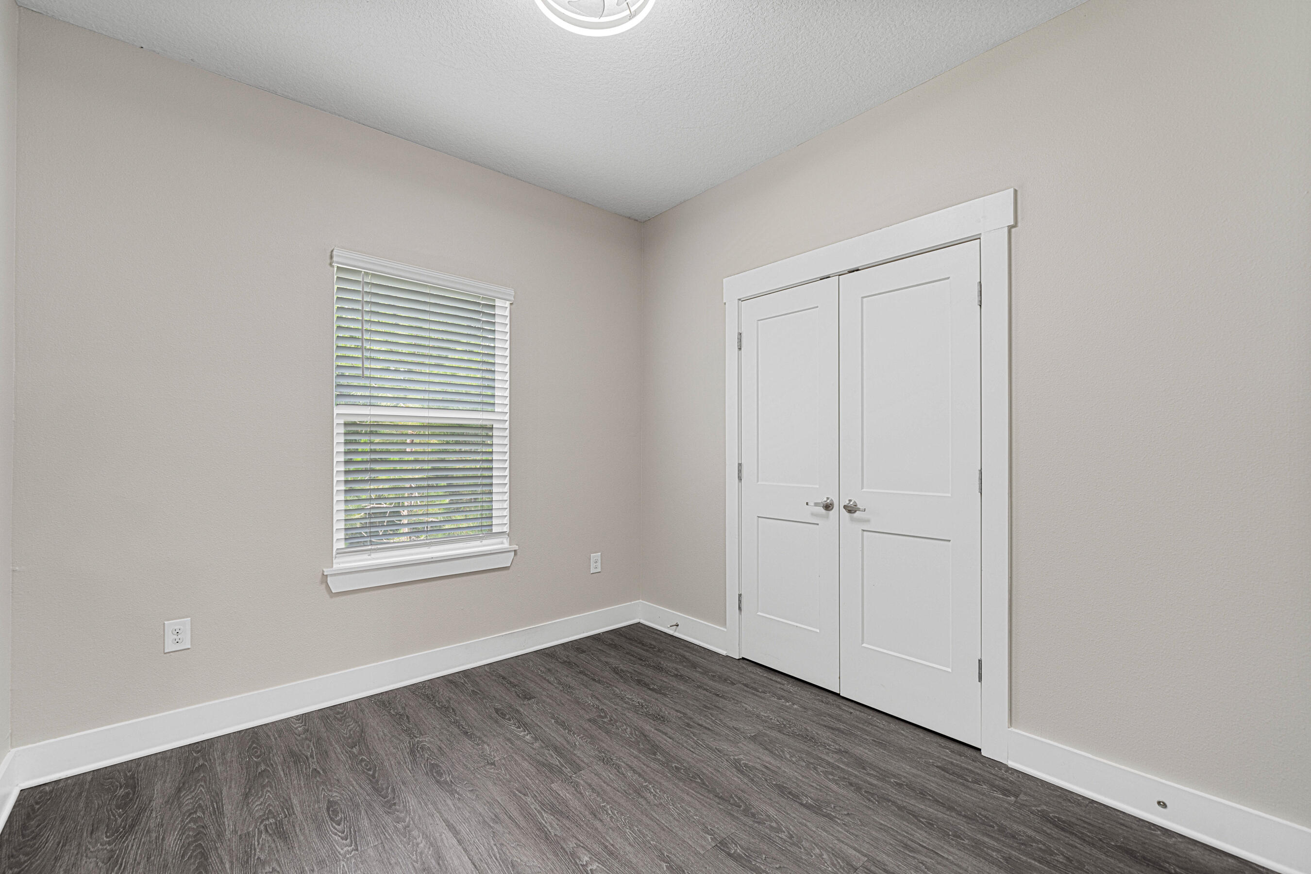 182 North Sand Palm Road Freeport, FL 32439 - Photo 25 of 38 an empty room with wooden floor and windows