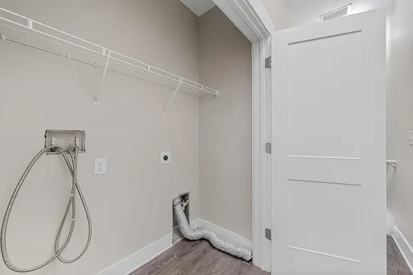 a view of a room with wooden floor