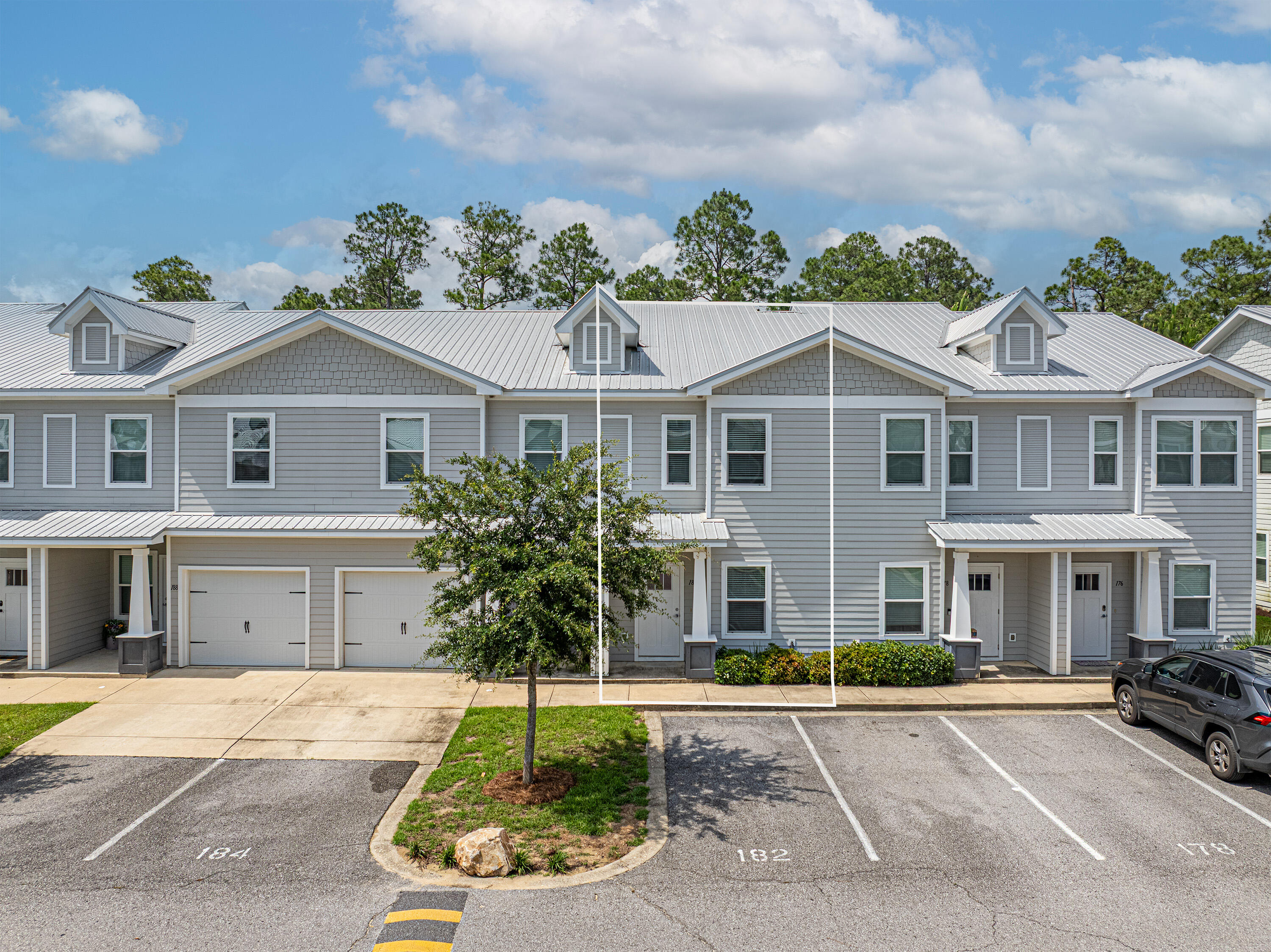 182 North Sand Palm Road Freeport, FL 32439 - Photo 32 of 38 a front view of a house with a yard and potted plants
