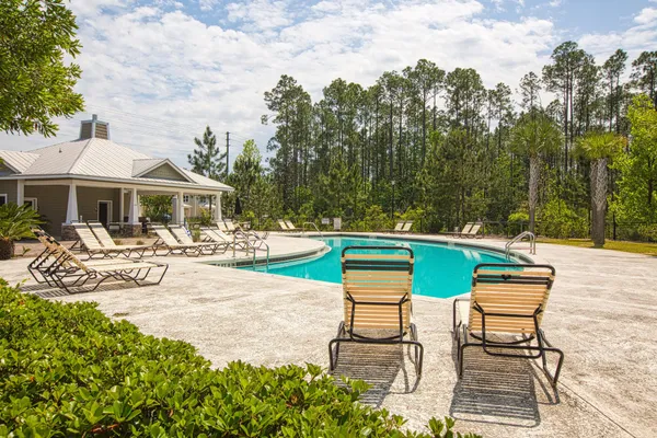 a swimming pool with outdoor seating and yard