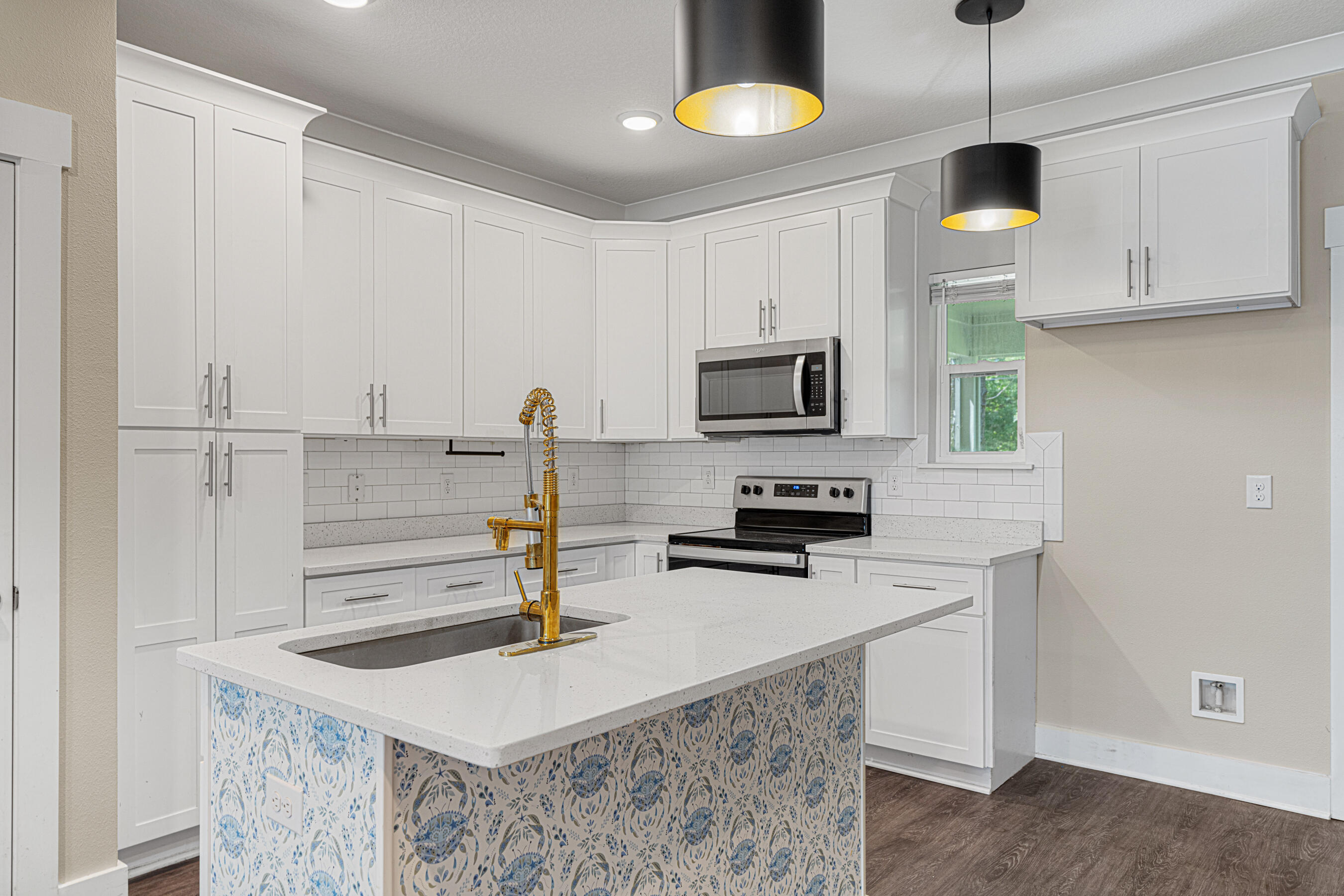 182 North Sand Palm Road Freeport, FL 32439 - Photo 6 of 38 a kitchen with kitchen island a sink stainless steel appliances and cabinets