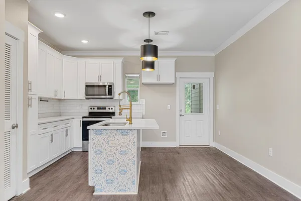 a kitchen with stainless steel appliances a stove refrigerator sink and cabinets