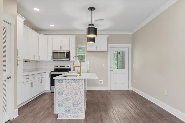 a kitchen with stainless steel appliances a stove refrigerator sink and cabinets