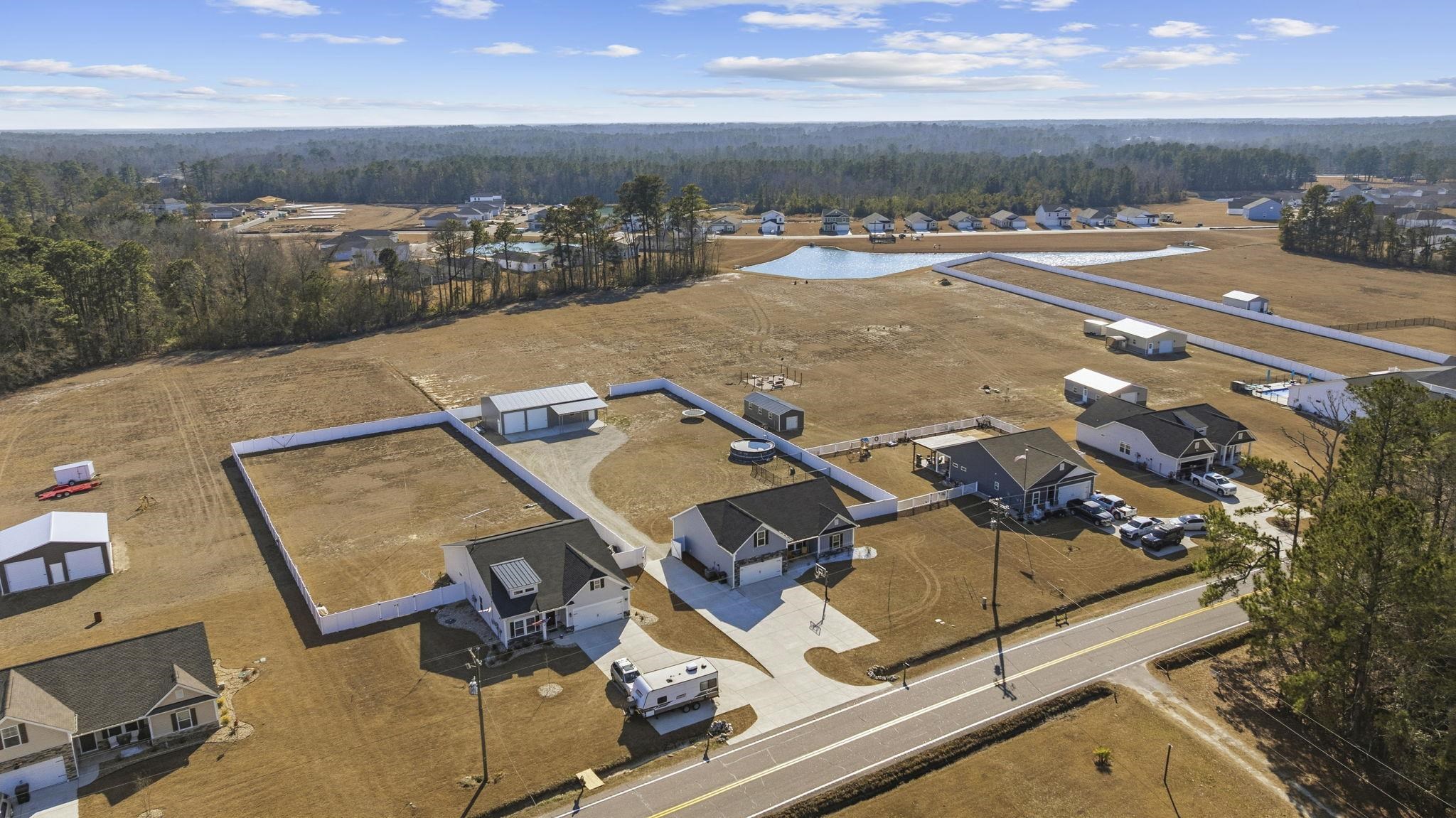 1010 Log Cabin Road Loris, SC 29569 - Photo 35 of 40 Aerial perspective of suburban area featuring a forest