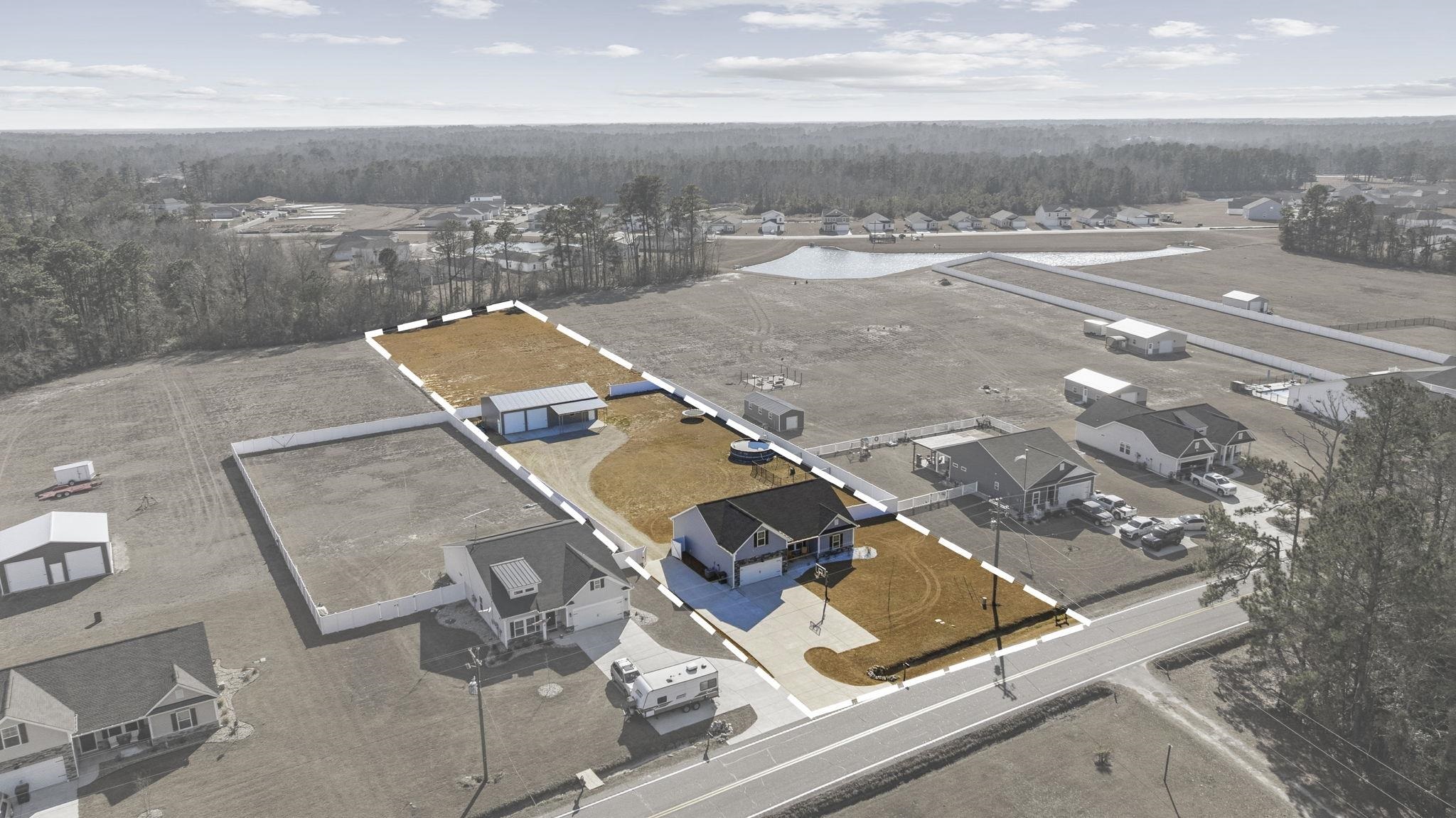 1010 Log Cabin Road Loris, SC 29569 - Photo 36 of 40 Aerial view of residential area with a heavily wooded area