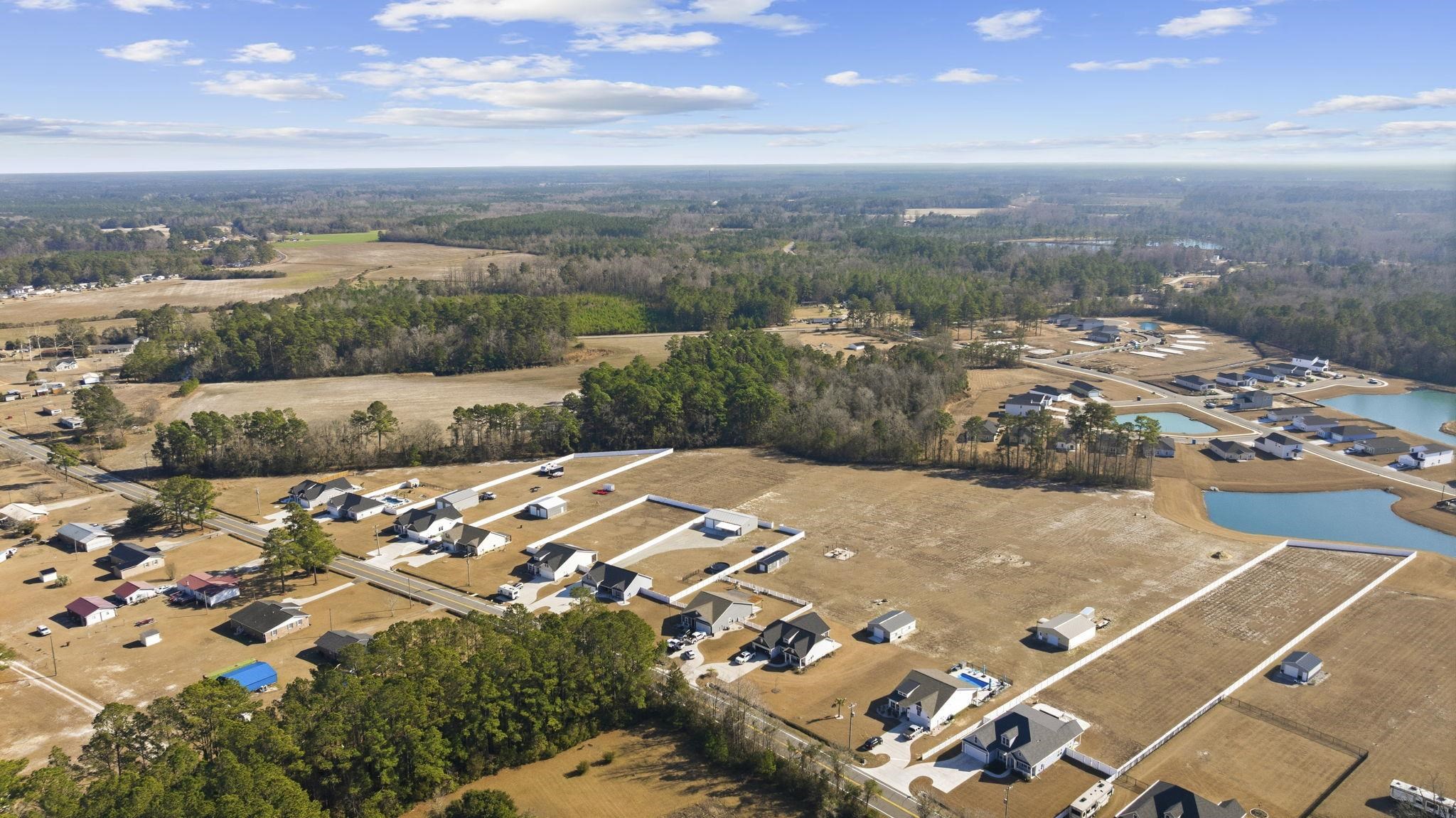 1010 Log Cabin Road Loris, SC 29569 - Photo 37 of 40 View of property location with a large body of water and a heavily wooded area