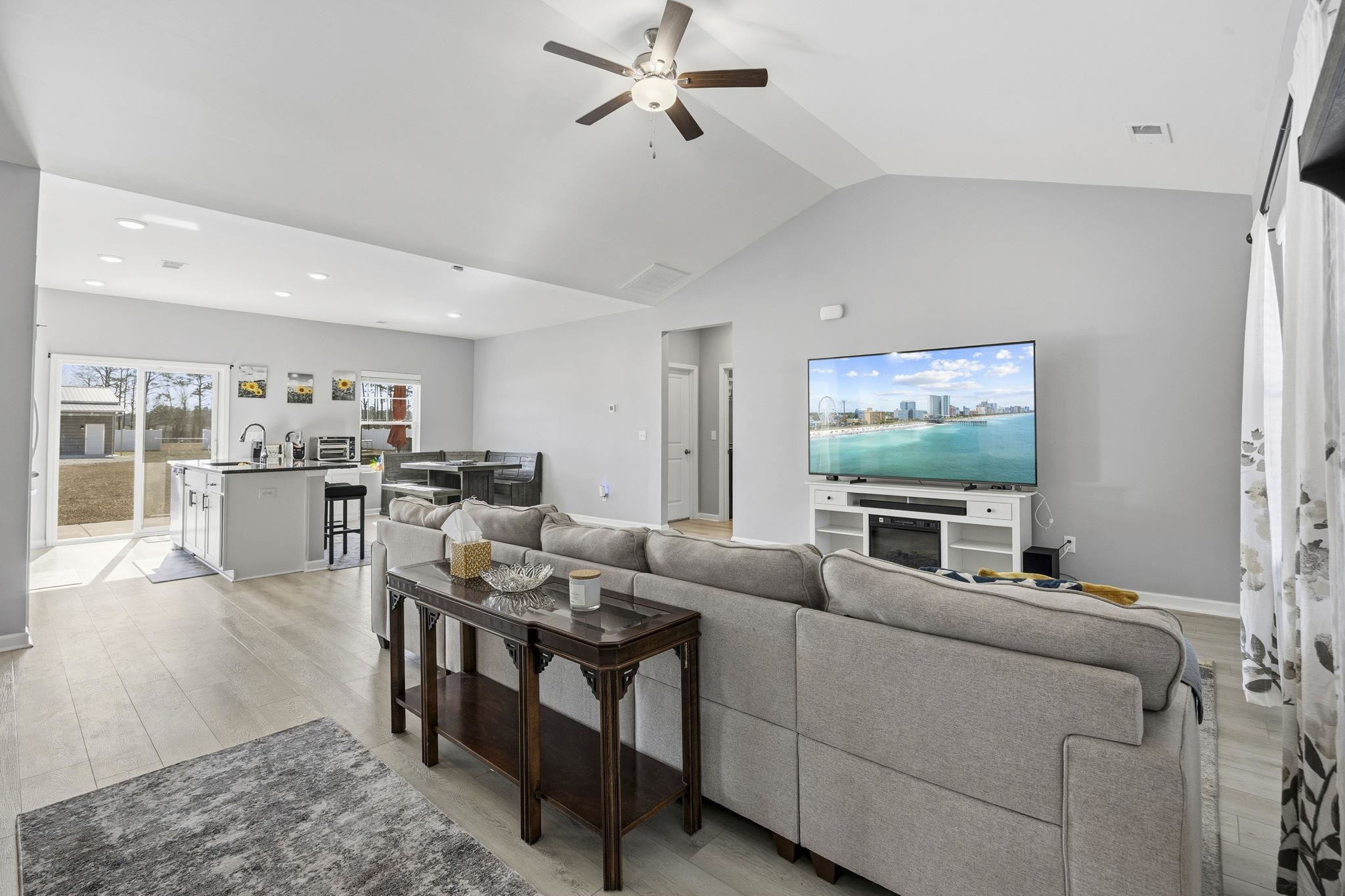 1010 Log Cabin Road Loris, SC 29569 - Photo 5 of 40 Living room with light wood-style floors, a ceiling fan, vaulted ceiling, and recessed lighting