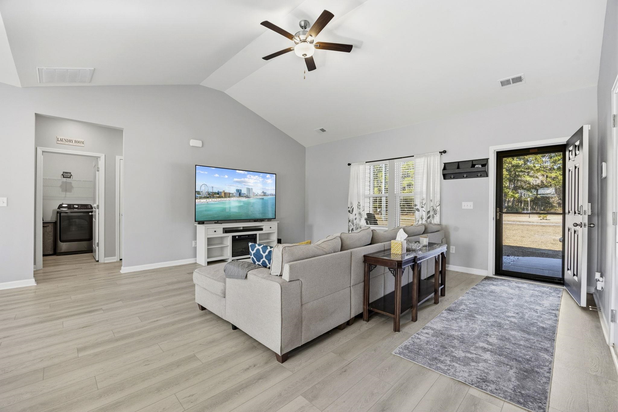 1010 Log Cabin Road Loris, SC 29569 - Photo 7 of 40 Living area with a ceiling fan, light wood finished floors, washer / clothes dryer, and high vaulted ceiling