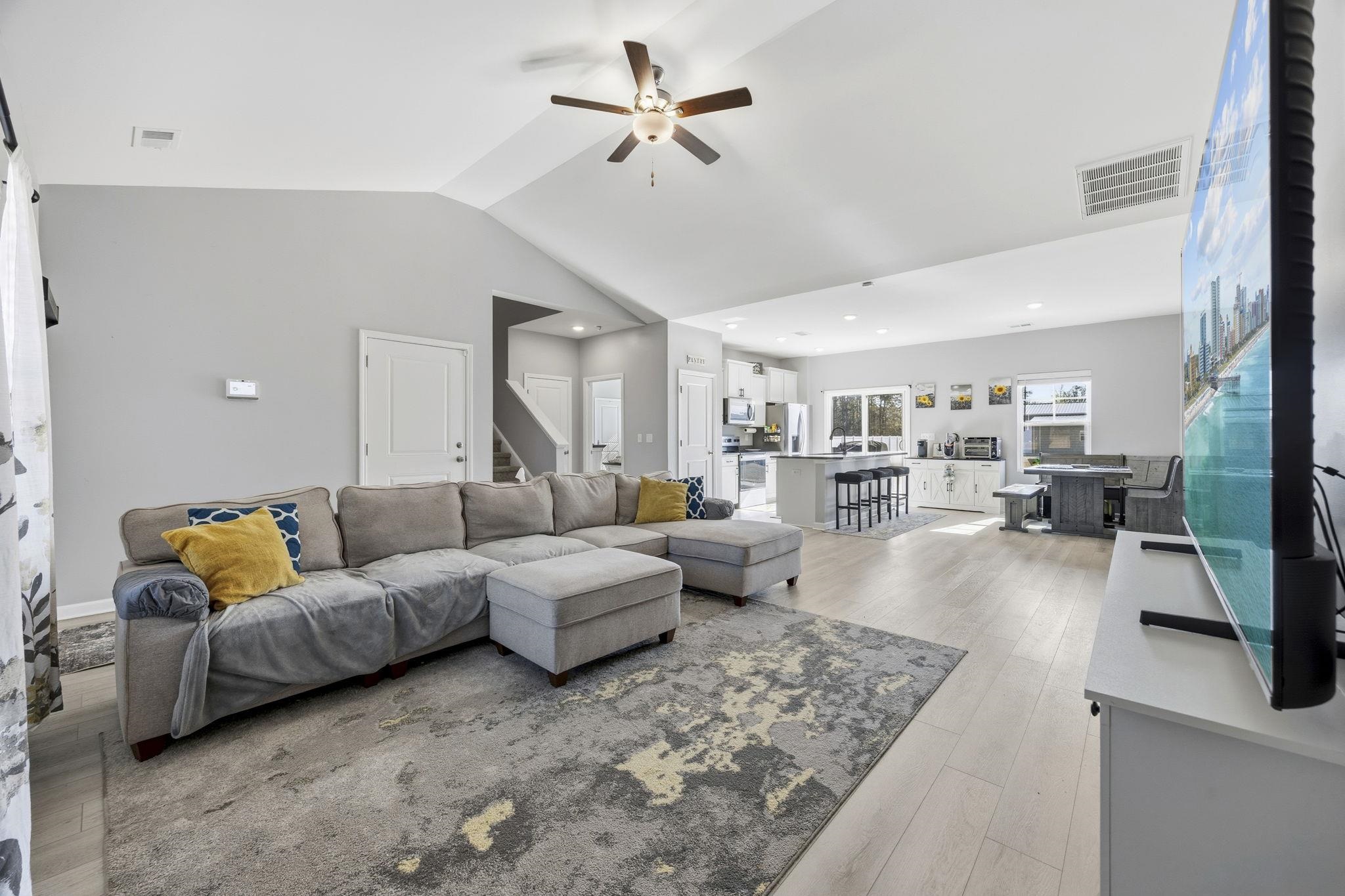 1010 Log Cabin Road Loris, SC 29569 - Photo 9 of 40 Living room with ceiling fan, light wood-style flooring, stairs, high vaulted ceiling, and recessed lighting