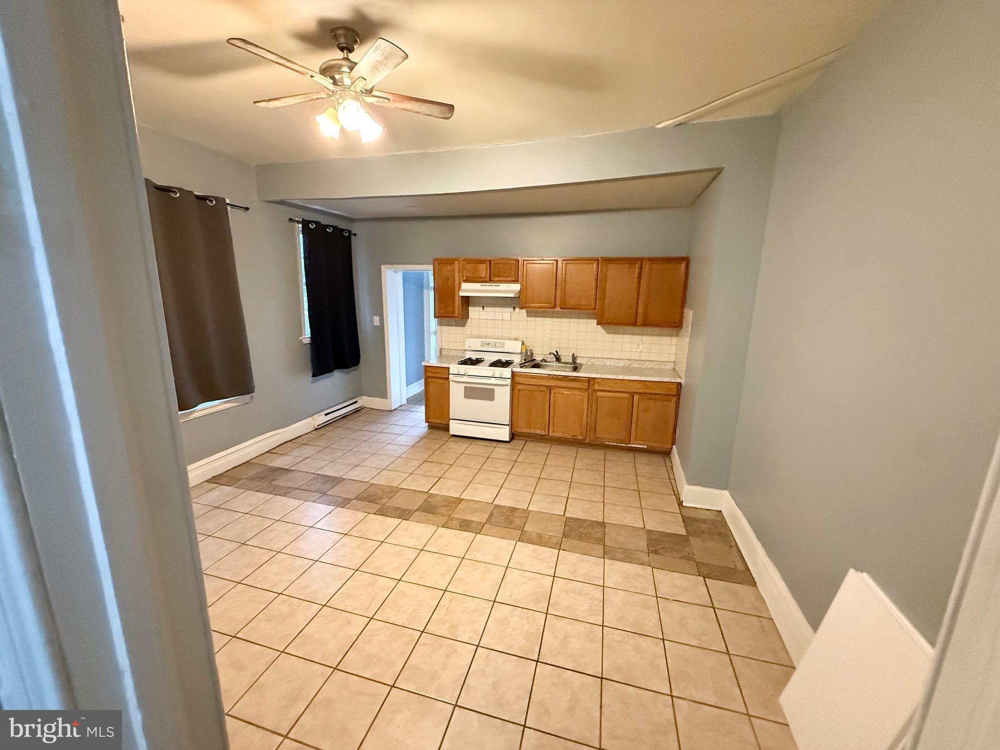 1328 North 54th Street, Unit 1 Philadelphia, PA 19131 - Photo 5 of 6 a room with window and stainless steel appliances