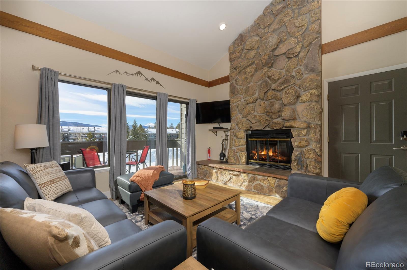 83 County Road, Unit F7 Fraser, CO 80442 - Photo 2 of 20 a living room with furniture and a fireplace