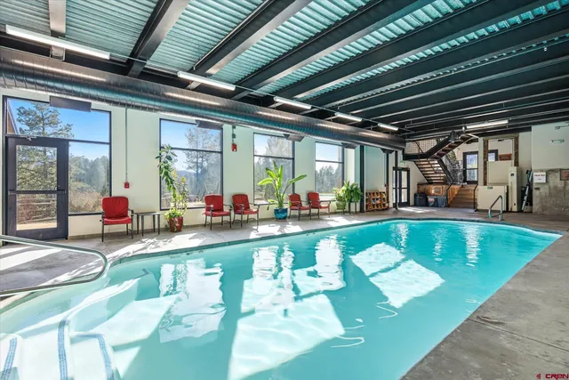 a view of a swimming pool with outdoor seating