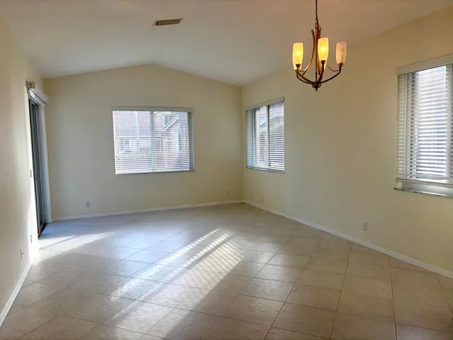 a living room with fireplace furniture and a potted plant