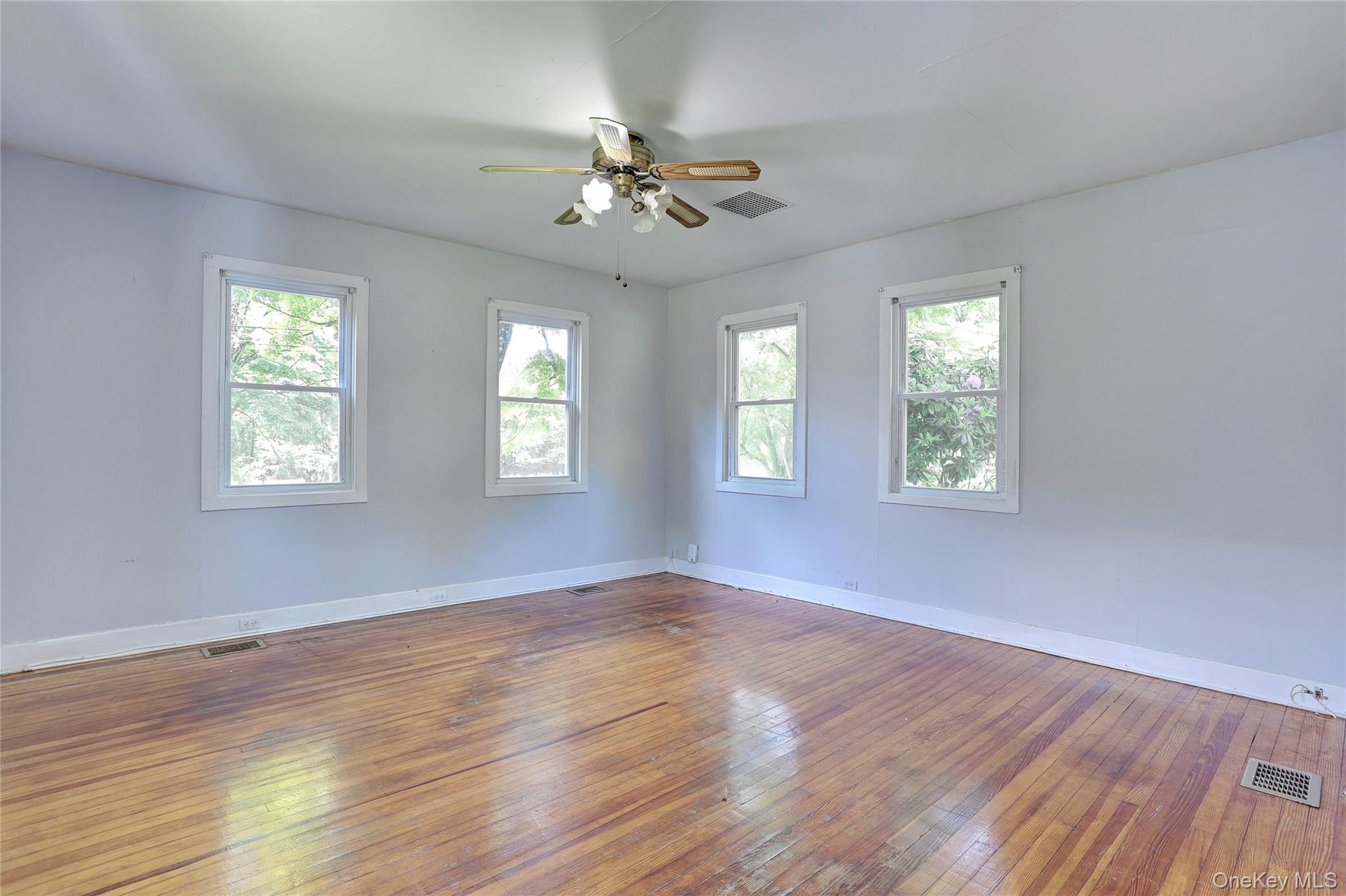 500 Haverstraw Road Suffern, NY 10901 - Photo 12 of 36 a view of an empty room with wooden floor and a window