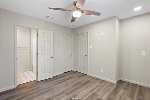 a view of an empty room with wooden floor