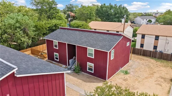 an aerial view of a house with a yard